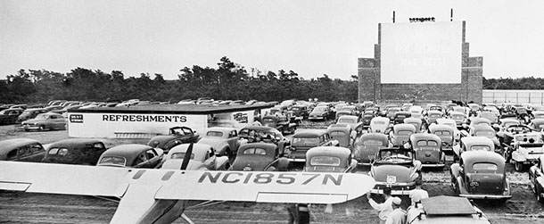 An air-minded proprietor decided the drive-in theatre wasn’t enough in this air age, so it’s been combined with a landing strip and becomes part fly-in theatre. Here a light plane is parked behind a group of cars at the East Dennis, Mass., Drive-In Fly-In Theatre at its opening on July 16, 1949. Admission, $1 per person, is the same for movie going pilots as it is for autoists. (AP Photo)