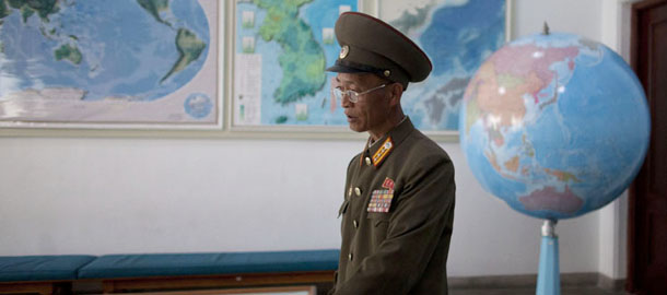 A military officer shows a map at a geology classroom at the Mangyongdae Revolutionary School, an elite military school for boys ages eleven to eighteen, on the outskirts of Pyongyang, North Korea, Monday, June 17, 2013. After months of threatening to wage a nuclear war, North Korea did an about-face Sunday and issued a surprise proposal to the United States, its No. 1 enemy: Let's talk. (AP Photo/Alexander F. Yuan)