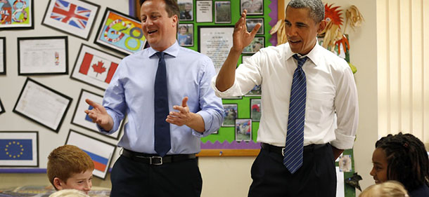 ENNISKILLEN, UNITED KINGDOM - JUNE 17: U.S. President Barack Obama, rear right, and British Prime Minister David Cameron, rear left, speak to students working on a school project about the G-8 summit during a visit to the Enniskillen Integrated Primary School on June 17, 2013 in Enniskillen, Northern Ireland. Leaders from the G8 nations have gathered to discuss numerous topics with the situation in Syria expected to dominate the talks. (Photo by Matt Dunham - WPA Pool/Getty Images)
