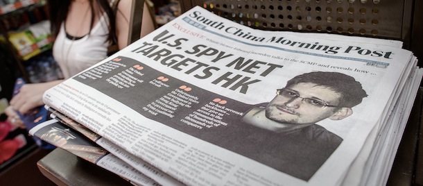 A woman walks past an edition of the South China Morning Post carrying the story of former US spy Edward Snowden (R) on its front page in Hong Kong on June 13, 2013. Snowden broke his silence in an interview to the South China Morning Post on June 12, vowing to fight any bid to extradite him from Hong Kong and accusing Washington's cyber-troops of prying into hundreds of thousands of targets globally including many in China. AFP PHOTO / Philippe Lopez (Photo credit should read PHILIPPE LOPEZ/AFP/Getty Images)