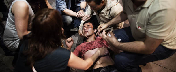 A beaten and shocked demonstrator is helped by other protesters on June 9, 2013 after being confronted by riot police on Kizilay square in Ankara. Turkish Prime Minister Recep Tayyip Erdogan on June 9 told supporters his patience "has a limit" as he went on the offensive against mass protests to his Islamic-rooted government's decade-long rule. As tens of thousands of protesters massed in Istanbul, Ankara and the western city of Izmir, in unrest now in its 10th day, Erdogan staged his own rallies across three cities to fire up loyalists of his ruling Justice and Development Party (AKP). The nationwide unrest first erupted on May 31 with a tough police crackdown on a campaign to save Istanbul's Gezi Park from demolition. The trouble spiralled into mass protests against Erdogan and his party, seen as increasingly authoritarian. AFP PHOTO / MARCO LONGARI (Photo credit should read MARCO LONGARI/AFP/Getty Images)