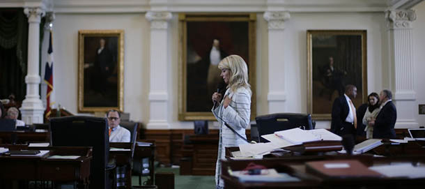 Sen. Wendy Davis, D-Fort Worth, cener, filibusters in an effort to kill an abortion bill, Tuesday, June 25, 2013, in Austin, Texas. The bill would ban abortion after 20 weeks of pregnancy and force many clinics that perform the procedure to upgrade their facilities and be classified as ambulatory surgical centers. (AP Photo/Eric Gay)