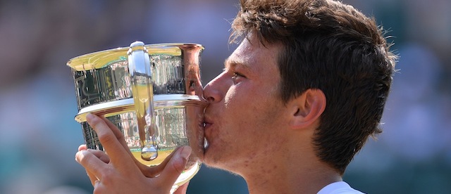 Italy's Gianluigi Quinzi raises the winner's cup after beating South Korea's Chung Hyeon in the boy's singles final on day thirteen of the 2013 Wimbledon Championships tennis tournament at the All England Club in Wimbledon, southwest London, on July 7, 2013. AFP PHOTO / CARL COURT - RESTRICTED TO EDITORIAL USE (Photo credit should read CARL COURT/AFP/Getty Images)