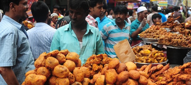Bangladeshi street vendors prepare Iftar food for breaking the daytime fast, on the first day of Ramadan, the holy fasting month of Islam, at a traditional bazaar in the old part of Dhaka on July 11 , 2013. Like millions of Muslim around the world, Bangladeshi Muslims celebrated the month of Ramadan by abstaining from eating, drinking, and smoking as well as sexual activities from dawn to dusk. AFP PHOTO/ Munir uz ZAMAN (Photo credit should read MUNIR UZ ZAMAN/AFP/Getty Images)