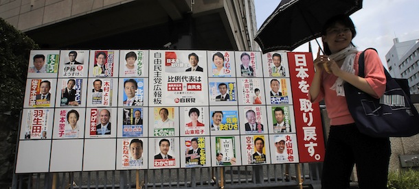 Woman walks past posters of the July 21 upper house parliamentary elections at Liberal Democratic Party (LDP) headquarters in Tokyo, Friday, July 19, 2013.(AP Photo/Itsuo Inouye)
