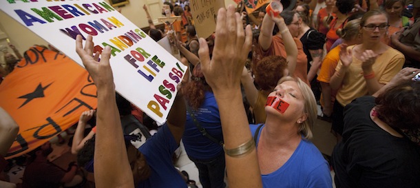 Opponents and supporters of abortion rights rally in the State Capitol rotunda in Austin, Texas on Friday, July 12, 2013. The Texas Senate convened Friday afternoon to debate and ultimately vote on some of the nation's toughest abortion restrictions, its actions being watched by fervent demonstrators on either side of the issue. (AP Photo/Tamir Kalifa)