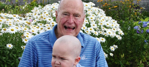 This Wednesday July 24, 2013 photo provided by the Office of George Bush shows President George H. W. Bush with Patrick (last name withheld at family's request), 2, in Kennebunkport, Maine. Bush this week joined members of his Secret Service detail in shaving his head to show solidarity for Patrick, who is the son of one of the agents. The child is undergoing treatment for leukemia and is losing his hair as a result. (AP Photo/Office of George Bush)