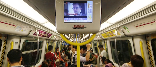 A TV screen shows the news of Edward Snowden, a former CIA employee who leaked top-secret documents about sweeping U.S. surveillance programs, in the underground train in Hong Kong Sunday, June 16, 2013. Top U.S. intelligence officials said Saturday that information gleaned from two controversial data-collection programs run by the National Security Agency thwarted potential terrorist plots in the U.S. and more than 20 other countries — and that gathered data is destroyed every five years. (AP Photo/Kin Cheung)