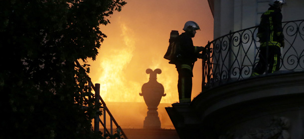 Firemen fight a blaze at the 17 century Hotel Lambert on July 10, 2013 in Paris. Hotel Lambert, by the architect Louis Le Vau located at the tip of the Ile Saint-Louis in Paris, was purchased in 2007 by the brother of the Emir of Qatar and currently being restore. AFP PHOTO / KENZO TRIBOUILLARD (Photo credit should read KENZO TRIBOUILLARD/AFP/Getty Images)
