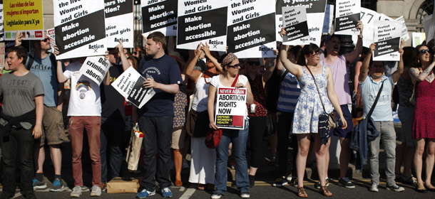 Pro-Choice supporters hold placards in front of the gates of the Irish Parliament building in Dublin on July 10, 2013 during a demonstration ahead of a vote to introduce abortion in limited cases where the mother's life is at risk. The bill follows a 2010 European Court of Human Rights ruling that found Ireland failed to implement properly the constitutional right to abortion where a woman's life is at risk. AFP PHOTO / PETER MUHLY (Photo credit should read PETER MUHLY/AFP/Getty Images)