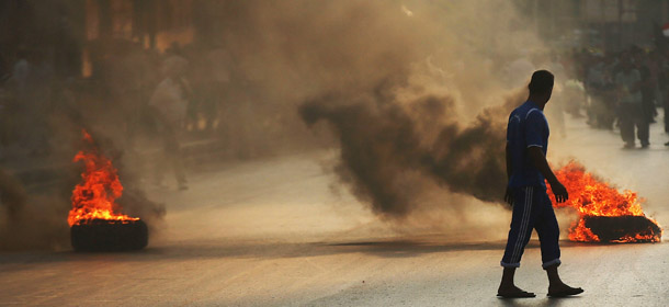 CAIRO, EGYPT - JULY 05: Supporters of former Egyptian President Mohammed Morsi burn tires along a bridge in protest over his removal by the Egyptian military on July 5, 2013 in Cairo, Egypt. Adly Mansour, chief justice of the Supreme Constitutional Court, was sworn in as the interim head of state in ceremony in Cairo in the morning of July 4, the day after Morsi was placed under house arrest by the Egyptian military and the Constitution was suspended. (Photo by Spencer Platt/Getty Images)