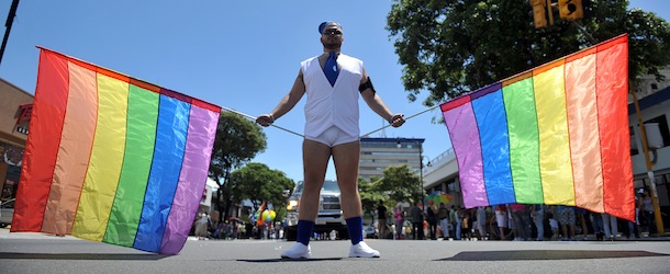 A man holds rainbow flags during a Gay Pride parade in San Jose, on June 30, 2013. AFP PHOTO/Hector RETAMAL (Photo credit should read HECTOR RETAMAL/AFP/Getty Images)