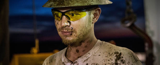 WILLISTON, ND - JULY 23: Russell Girsh, a floor hand for Raven Drilling, pauses while drilling for oil in the Bakken shale formation on July 23, 2013 outside Watford City, North Dakota. North Dakota has been experiencing an oil boom in recent years, due in part to new drilling techniques including hydraulic fracturing and horizontal drilling. In April 2013, The United States Geological Survey released a new study estimating the Bakken formation and surrounding oil fields could yield up to 7.4 billion barrels of oil, doubling their estimate of 2008, which was stated at 3.65 billion barrels of oil. Workers for Raven Drilling work 12-hour days, working 14 days straight, and then having 14 days off. They stay at a camp nearby. (Photo by Andrew Burton/Getty Images)