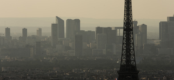 A picture taken late on July 14, 2013 shows the Eiffel tower in Paris and the business district of La Defense in the background. AFP PHOTO / FRED DUFOUR (Photo credit should read FRED DUFOUR/AFP/Getty Images)