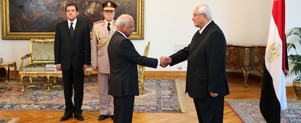This image released by the Egyptian Presidency on Tuesday, July 16, 2013 shows interim President Adly Mansour, right, shaking hands with Prime Minister Hazem el-Biblawi during a sweararing-in ceremony for new cabinet ministers at the presidential palace in Cairo, Egypt. Egypt's interim president has sworn in a new Cabinet, the first since the ouster of the Islamist president by the military nearly two weeks ago. The new government, sworn in Tuesday, is led by Prime Minister Hazem el-Beblawi, an economist, and features the promotion of Defence Minister Gen. Abdel-Fattah el-Sissi, who ousted Mohammed Morsi on July 3, to deputy prime minister. He also retains the defence portfolio. (AP Photo/Egyptian Presidency)