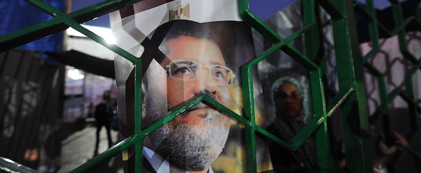 A poster festuring deposed president Mohamed Morsi is displayed on a gate as his supporters continue to hold a sit-in outside Rabaa al-Adawiya mosque on July 25, 2013 in Cairo. Egypt's military and Mohamed Morsi's camp sought separately to defuse soaring tensions on the eve of rival rallies called by the army and Islamists who back the ousted president. AFP PHOTO/FAYEZ NURELDINE (Photo credit should read FAYEZ NURELDINE/AFP/Getty Images)