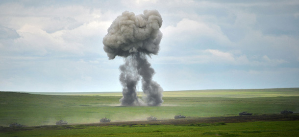 Russian Army Engenering tanks drive near the Baikal Lake in Russia on Wednesday, July 17, 2013. Chief of Russia's military's General Staff Valery Gerasimov sits at center. Russia has launched its biggest military maneuvers since Soviet times, involving 160,000 troops and about 5,000 tanks across Siberia and the far eastern region. (AP Photo/RIA Novosti, Alexei Nikolsky, Presidential Press Service)