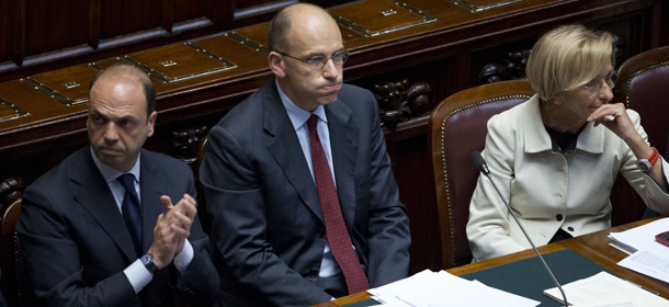 Italian Premier Enrico Letta sits in between Interior Minister Angelino Alfano left, and Foreign Minister Emma Bonino during a vote of confidence to confirm the government, in the lower house of Parliament, in Rome, Monday, April 29, 2013. Letta's new government is under pressure to draft economic and social reforms, including measures to get Italians back to work. (AP Photo/Andrew Medichini)