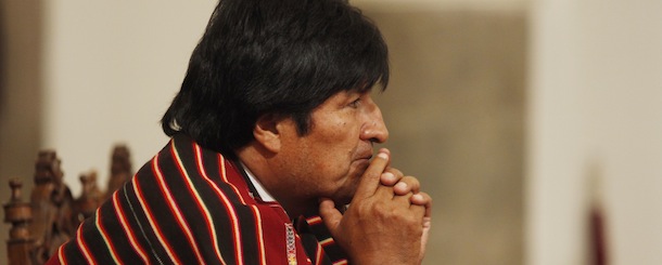 In this June 15, 2012 photo, wearing a traditional poncho, Bolivia's President Evo Morales gestures during a ceremony at the government palace in La Paz, Bolivia. Morales said on Friday, Nov. 9, 2012 that his personal wealth has increased by $100,000 dollars due to ponchos given to him as gifts from mayors and supporters during his public appearances. (AP Photo/Juan Karita)