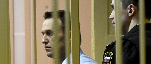 Russian protest leader Alexei Navalny walks past a guard as he attends a hearing of his case in a court in the provincial northern city of Kirov on April 24, 2013. Navalny went today on trial on charges that he says were ordered by President Vladimir Putin in revenge for him daring to oppose the Kremlin. AFP PHOTO/KIRILL KUDRYAVTSEV (Photo credit should read KIRILL KUDRYAVTSEV/AFP/Getty Images)