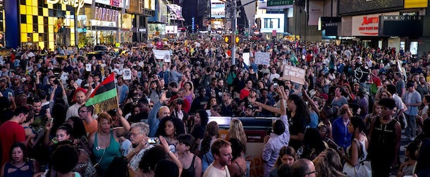 Throngs of marches arrive on Times Square, Sunday, July 14, 2013, in New York, for a protest against the acquittal of volunteer neighborhood watch member George Zimmerman in the 2012 killing of 17-year-old Trayvon Martin in Sanford, Fla. Demonstrators upset with the verdict protested mostly peacefully in Florida, Milwaukee, Washington, Atlanta and other cities overnight and into the early morning. (AP Photo/Craig Ruttle)