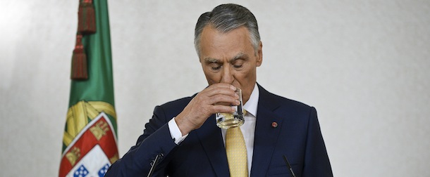Portuguese President Anibal Cavaco Silva drinks water as he addresses the nation from Belem Presidential palace in Lisbon on July 21, 2013. Cavaco Silva called the parties to compromize and keep the government running on an attempt to avoid snap elections before July 2014, during this week the parties were in negotiations but the understanding was not achieved today the President announced that the government will keep the present government in office. AFP PHOTO/ PATRICIA DE MELO MOREIRA (Photo credit should read PATRICIA DE MELO MOREIRA/AFP/Getty Images)