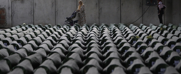 Bosnian women look for their relatives among 409 newly identified Srebrenica victims at the Potocari memorial cemetery near Srebrenica, 160 kilometers east of Sarajevo, Bosnia and Herzegovina, Tuesday, July 9, 2013. A burial ceremony for 409 victims will be held on Thursday, July 11, 2013 in Potocari, on the 18th anniversary of the Srebrenica tragedy when in summer 1995 Bosnian Serb forces stormed the enclave and systematically killed thousands of Bosnian Muslims. (AP Photo/Amel Emric)
