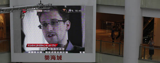 A TV screen shows the news of Edward Snowden, a former CIA employee who leaked top-secret documents about sweeping U.S. surveillance programs, at a shopping mall in Hong Kong Friday, June 21, 2013. President Barack Obama is holding his first meeting with a privacy and civil liberties board Friday as he seeks to make good on his pledge to have a public discussion about secretive government surveillance programs. (AP Photo/Kin Cheung)