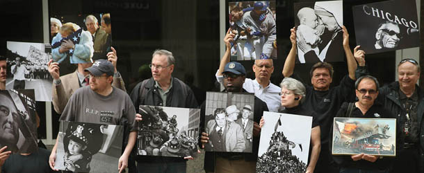 CHICAGO, IL - JULY 30: Current and former Chicago Sun-Times newspaper employees and their supporters stage a photo exhibit of images taken by the newspaper's former photography staff outside the Chicago Sun-Times' offices on July 30, 2013 in Chicago, Illinois. The pop-up protest, organzied by the Chicago Newspaper Guild, was held to mark the two-month anniversary since the newspaper fired its photography staff. (Photo by Scott Olson/Getty Images)