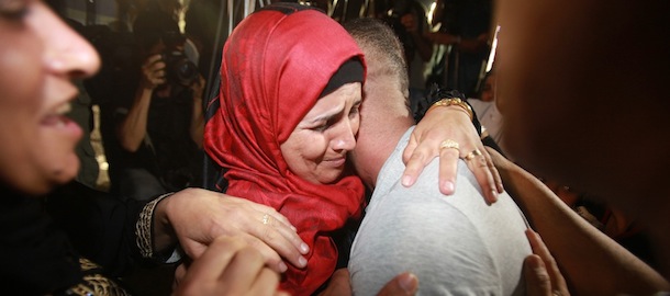 Palestinian prisoners freed from Israeli detention are greeted in the city of Ramallah on August 14, 2013. The release of the prisoners, all but one of whom were jailed before the Palestinian Authority was formed in 1994, has been hailed by Palestinian negotiators but has incensed some Israeli officials. AFP PHOTO / ABBAS MOMANI (Photo credit should read ABBAS MOMANI/AFP/Getty Images)