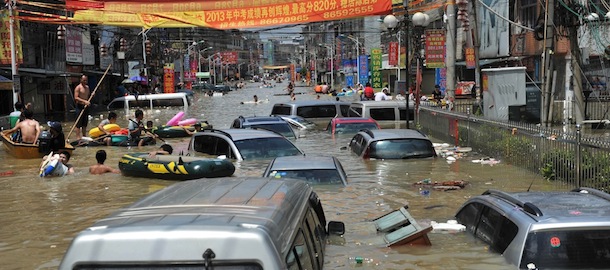 This picture taken on August 19, 2013 shows vehicles submerged by water in the flood-hit Chaonan district of Shantou, in southern China's Guangdong province. Devastating floods at opposite ends of China have left 105 people dead and another 115 missing in recent days, state media said on August 19. CHINA OUT AFP PHOTO (Photo credit should read STR/AFP/Getty Images)