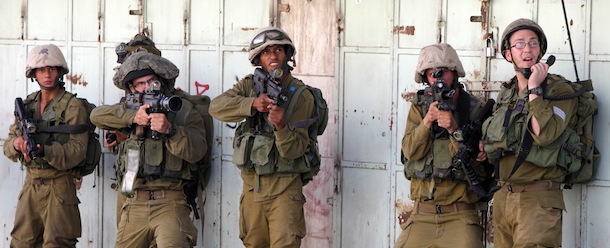 Israeli soldiers point their guns at Palestinian stones throwers during a clashes on August 27,2013 in the city center of the West Bank town of Hebron. Israeli-Palestinian peace talks slated for August 26 were scrapped after three Palestinians were shot dead in the West Bank, a Palestinian official said, although the US sponsors of the process denied the report. AFP PHOTO/HAZEM BADER (Photo credit should read HAZEM BADER/AFP/Getty Images)