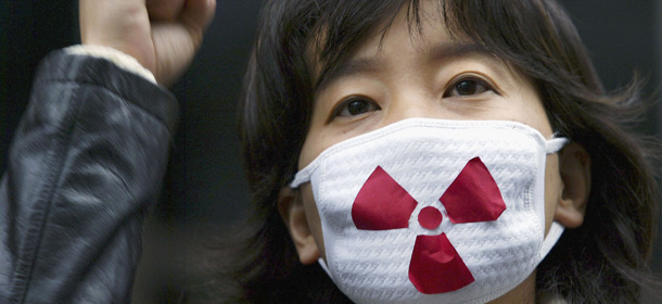 SEOUL, SOUTH KOREA - NOVEMBER 10: A South Korean environmental activist protests during a rally in front of the French cultural center on November 10, 2004 in Seoul, South Korea. The rally commemorated a 21-year-old French protestor who was crushed to death under the wheels of a train transporting nuclear waste in France after he had attached himself to the railway track to stop a shipment of nuclear waste last Sunday, November 7, 2004. (Photo by Chung Sung-Jun/Getty Images)