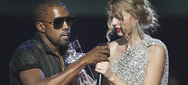 Singer Kanye West takes the microphone from singer Taylor Swift as she accepts the "Best Female Video" award during the MTV Video Music Awards on Sunday, Sept. 13, 2009 in New York. (AP Photo/Jason DeCrow)
