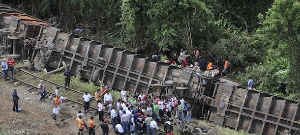 In this image released by the Tabasco state government press office on Sunday Aug. 25, 2013, rescue workers try to evacuate the injured after a cargo train, known as "the Beast", derailed near the town of Huimanguillo, southern Mexico. The cargo train, carrying at least 250 Central American hitchhiking migrants derailed in a remote region, killing at least five people and injuring dozens, authorities said. (AP Photo/Tabasco state government press office)
