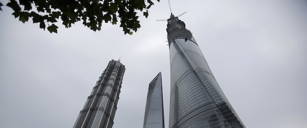 The Shanghai Tower, right, is seen among other skyscrapers prior to the topping off ceremony in Shanghai, China, Saturday, Aug. 3, 2013. The Shanghai Tower is set to become the tallest building in China which is planned to be complete in 2014. (AP Photo/Eugene Hoshiko)