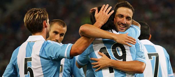 ROME, ITALY - AUGUST 14: Ever Banega(C) with his teammates Lucas Biglia (L) and Gonzalo Higuain of Argentina celebrates after scoring the second team's goal during the international friendly match between Italy v Argentina at Stadio Olimpico on August 14, 2013 in Rome, Italy. (Photo by Paolo Bruno/Getty Images)