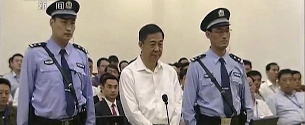 In this image taken from video, disgraced politician Bo Xilai, center, stands in the courtroom, flanked by police guards at Jinan Intermediate People's Court in eastern China's Shandong province on Thursday Aug. 22, 2013. Bo went on trial Thursday accused of abuse of power and netting more than $4 million in bribery and embezzlement, marking the ruling Communist Party's attempts to put to rest one of China's most lurid political scandals in decades. (AP Photo/CCTV via AP Video) CHINA OUT, TV OUT