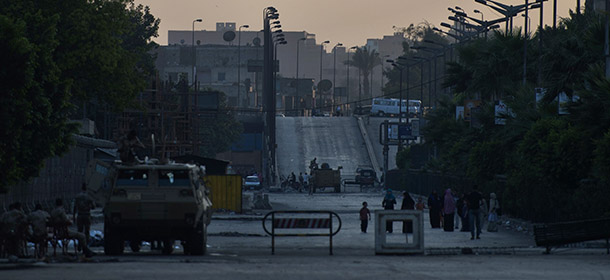 Egyptian troops block the way in the street leading to Al-Nahda Square in southern Cairo, on August 11, 2013 where the Muslim brotherhood and supporters of the deposed president Mohamed Morsi are taking part in a sit-in. The dispersal of Cairo sit-ins by loyalists of ousted Egyptian president Mohamed Morsi will be "gradual", with protesters given "several warnings" before police moves in, senior security officials told AFP. AFP PHOTO/ KHALED DESOUKI (Photo credit should read KHALED DESOUKI/AFP/Getty Images)