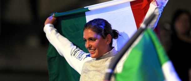 Arianna Errigo of Italy holds an Italian flag as she celebrates her win over Carolin Golubytskyi of Germany, not pictured, in the final of women’s individual foil competition at the World Fencing Championships in Budapest, Hungary, Wednesday, Aug. 7, 2013. (AP Photo/Imre Foldi, MTI)