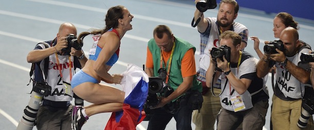 Russia's Yelena Isinbayeva celebrate winning gold in the women's pole vault final at the World Athletics Championships in the Luzhniki stadium in Moscow, Russia, Tuesday, Aug. 13, 2013. (AP Photo/Martin Meissner)