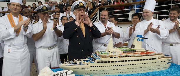 Gavin MacLeod, Capt. Stubing from television’s “The Love Boat”, prepares to blow out the candles on his cake as he celebrates his 80th birthday onboard Princess Cruises Golden Princess cruise ship, Wednesday, Mar. 2, 2011 in the Port of Los Angeles. The cake is a 5 foot long replica of The Pacific Princess, the original Love Boat. (AP Photo/Princess Cruises, Susan Goldman, handout)