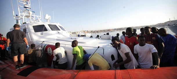 Migrants prepare to disembark in the island of Lampedusa, Italy, Wednesday, Aug. 7, 2013, after being rescued at sea by the Italian Coast Guard. Thousands of migrants heading to Europe arrive in Malta and Italy each year, often aboard unseaworthy boats. The Italian government has agreed to accept 102 migrants rescued at sea by a tanker that has been denied entry to Malta for two days. (AP Photo/Francesco Malavolta)