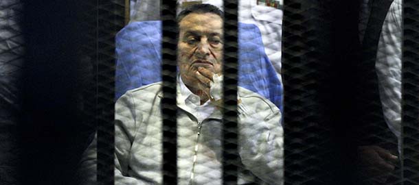 FILE - In this Monday, April 15, 2013 file photo, Egypt's deposed President Hosni Mubarak attends a hearing session in his retrial on appeal in Cairo, Egypt. Former Egyptian President Hosni Mubarak was back in court Saturday, May 11, 2013, to hear prosecutors say they are presenting new evidence in his retrial. Charges against Mubarak and others include allegations of involvement in the deaths of 900 protesters during Egypt's 2011 revolt as well as corruption. All have pleaded not guilty. (AP Photo/Ahmed Gomaa, File)