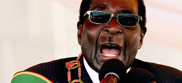 Zimbabwe President Robert Mugabe delivers a speech at the National Heroes Acre in Harare on August 12, 2013 during Heroes Day celebrations. Mugabe told those upset by his disputed landslide election win to "go hang," vowing his victory would never be overturned. Mugabe was declared the winner with 61 percent of the ballots, against Tsvangirai's 34 percent. Tsvangirai meanwhile vowed to expose "glaring evidence of the stolen vote" through a court bid. AFP PHOTO / JEKESAI NJIKIZANA (Photo credit should read JEKESAI NJIKIZANA/AFP/Getty Images)