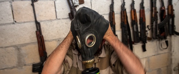A Syrian rebel tries on a gas mask seized from a Syrian army factory in the northwestern province of Idlib on July 18, 2013. Western countries say they have handed over evidence to the UN that Bashar al-Assad's forces have used chemical arms in the two-year conflict. More than 100,000 people have died in the conflict, which morphed from a popular movement for change into an insurgency after the regime unleashed a brutal crackdown on dissent. AFP PHOTO/DANIEL LEAL-OLIVAS (Photo credit should read DANIEL LEAL-OLIVAS/AFP/Getty Images)