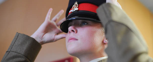 HARROGATE, ENGLAND - AUGUST 15: Junior Soldier Natalie Heart, 17, from Blackpool makes final preparations before a graduation parade for Junior Soldiers on August 15, 2013 in Harrogate, England. The Army Foundation College in Harrogate opened in 1998 and provides training for soldiers destined for all the Army's career paths and provides training for 1344 junior soldiers. During their time at the college the students are taught basic military skills and can achieve vocational qualifications, City and Guilds apprenticeships and take part in the Duke of Edinburgh Award Scheme. The graduation parade is the largest in Europe and is only exceeded in size by the Trooping of the Colour in London. Following the parade the students will go on for further specialist training before finally joining their units and moving forward with their military careers. (Photo by Ian Forsyth/Getty Images)