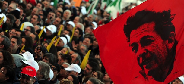 A demonstrator holds flag with a portrait of Enrico Berlinguer, a historic leader of Italian left-wing during a march to protest against Silvio Berlusconi's government called by the left-wing Democratic Party (PD) on December 11, 2010 in Rome. Berlusconi faces a knife-edge confidence vote in both houses of parliament on December 13 that could trigger his downfall or see the resilient Italian leader bounce back once again. AFP PHOTO / TIZIANA FABI (Photo credit should read TIZIANA FABI/AFP/Getty Images)