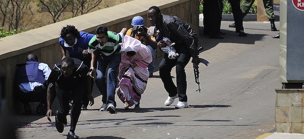 A policeman carry's a baby to safety after masked gunmen stormed an upmarket mall and sprayed gunfire on shoppers and staff, killing at least six on September 21, 2013 in Nairobi. The Gunmen have taken at least seven hostages, police and security guards told an AFP reporter at the scene. AFP PHOTO/SIMON MAINA (Photo credit should read SIMON MAINA/AFP/Getty Images)