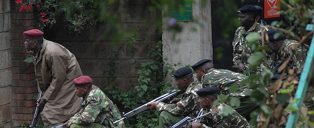 Armed Kenyan policemen take cover outside theWestgate mall in Nairobi, on September 23, 2013. At least 69 people are confirmed to have been killed and 63 more recorded missing in an ongoing Nairobi shopping mall siege, Kenya Red Cross. As the stand-off entered its third day, sustained bursts of rapid gunfire erupted at dawn and lasted 15 minutes, and soldiers posted around the mall ducked for cover.AFP PHOTO / SIMON MAINA (Photo credit should read SIMON MAINA/AFP/Getty Images)
